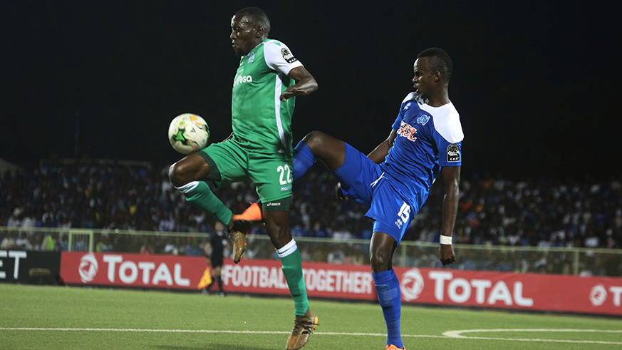 Gor Mahia 's goal scorer Meddie Kagere vies for the ball with Rayon Sports defender Faustin Usengimana