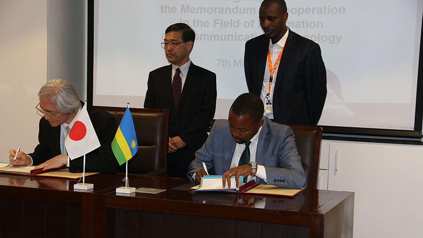 Tominaga (left) and Rurangirwa sign the agreement in Kigali yesterday. Courtesy.