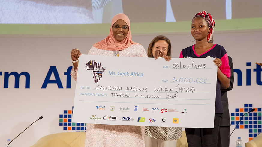 Nigerien Salissou Hassane Yari Latifa (R) poses with a Rwf3 million dummy cheque she received after winning the Miss Geek Africa 2018 in Kigali yesterday. The competition is designed to inspire African girls to be part of solving the continentu2019s challenges using technology and encourage them to choose a career in Science, Technology, Engineering and Math (STEM). Courtesy.