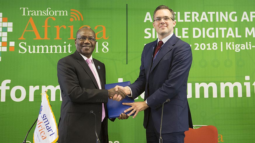 The Executive Director of Smart Africa Secretariat, Dr Hamadoun Toure (left), and Eric White, the Lead for the World Economic Forumu2019s Internet for All project, during the signing of a deal between the two parties. Courtesy.