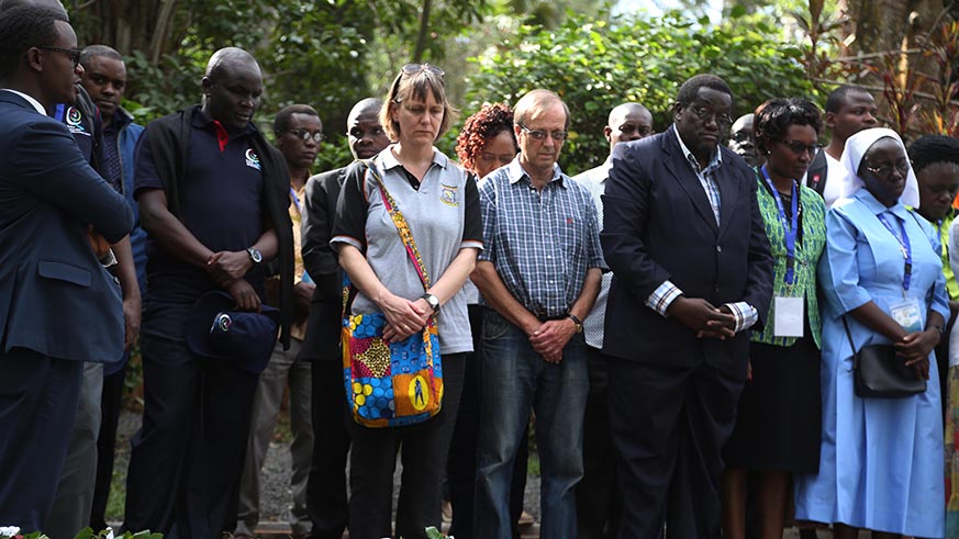 Regional academics observe a moment of silence to pay respect to the victims