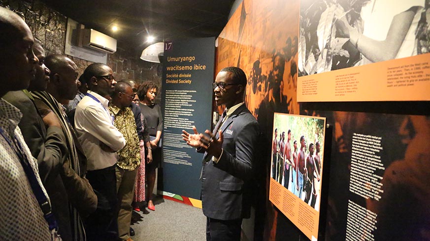 Visitors follow a guide as they tour inside the memorial to learn the history of Rwanda
