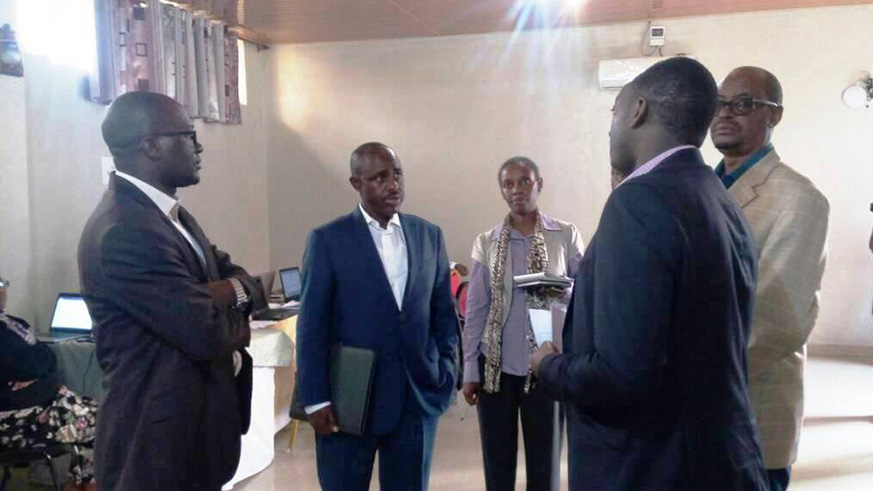 Minister of Education, Dr Eugene Mutimura(2nd-L) chatting with officials from Rwanda Education Board  while visiting in Musanze District a team of content writers for in-house textbook. Regis Umurengezi