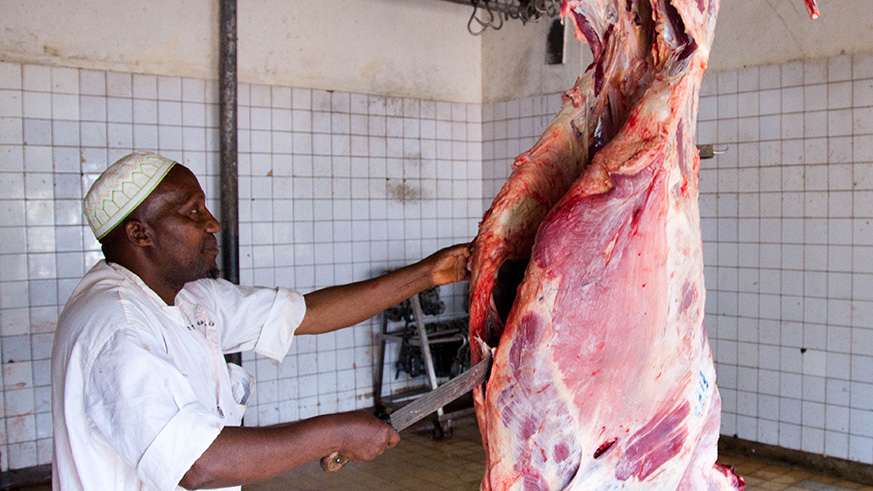 A butcher cuts meat at Nyabugogo abattoir. Dealers in the meat business have been tipped on professionalism, hygiene. File.