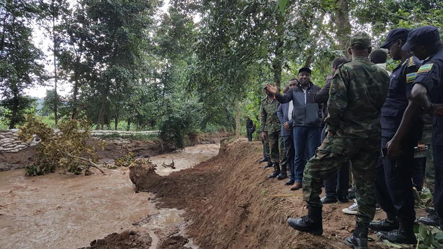 Prime Minister Edouard Ngirente (with raised hand) and officials from the Rwanda Defence Forces and Police assess the damage caused by River Sebeya in Rubavu District last week. Courtesy.