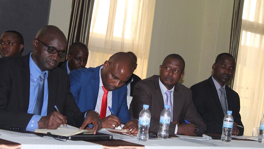 Rwanda Investigation Bureau officials write notes during the three-day retreat for  senior management at La Pallise Hotel in Nyamata. Courtesy.