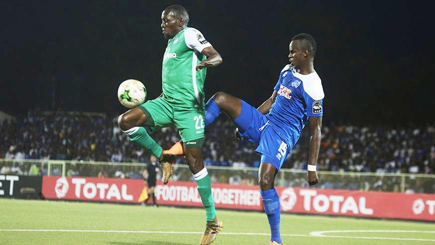 Rayon Sports will travel to Tanzania without star defender Faustin Usengimana (right), who was booked twice in the last two CAF games. Here, he challenges Gor Mahiau2019s forward Meddie Kagere in a 1-1 draw in Kigali just over a week ago. File.
