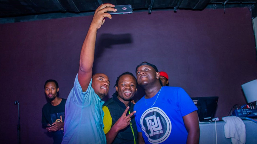 DJ Joe Mfalme (right) poses for selfies with fans at the show.