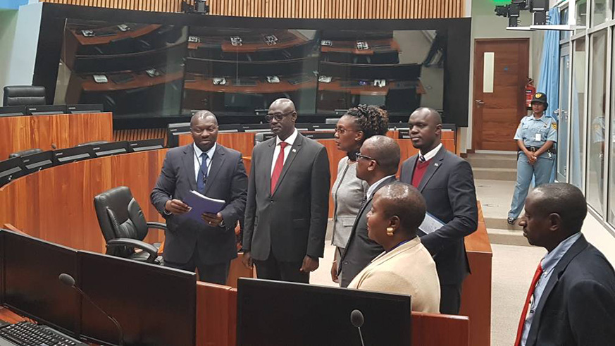 Justice Minister and Attorney General Johnston Busingye (2nd left) and his delegation are shown around one of the courtrooms of the former International Criminal Tribunal for Rwanda during his visit to the court last week. Courtesy