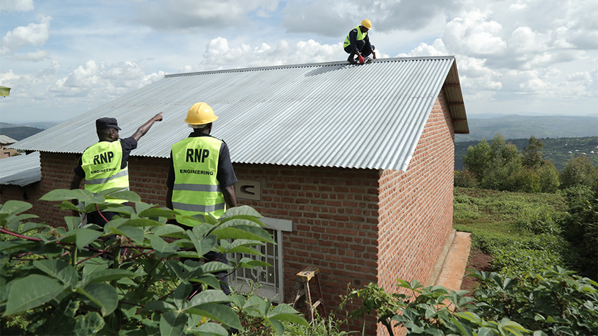 Police officers connecting one of the houses with solar energy.