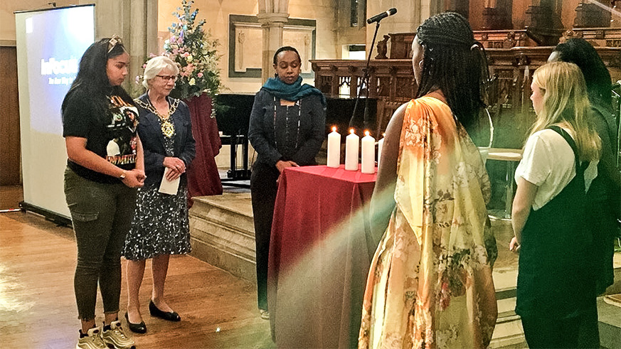 Rwandau2019s High Commissioner to the UK, Yamina Karitanyi (C), and youth representatives from Oxford light candles and observe a moment of silence in Oxford in honour of victims of the 1994 Genocide against the Tutsi. Courtesy.