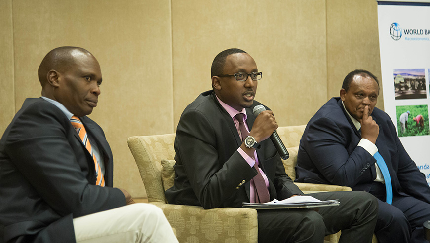 Michel Sebera, the Permanent Secretary at the Ministry of Trade and Industry (C), speaks during the presentation of a new report by World Bank Groupu2019s International Finance Corporation (IFC), on competition, as Francis Kariuki, the Director General of Kenya Competition Authority (left) and Ignace Rusenga Mihigo Bacyaha, IFCu2019s Resident Representative in Rwanda, look on. (Nadege Imbabazi)