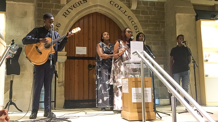 Mrs Jackie Mugabo performs a song alongside her sons