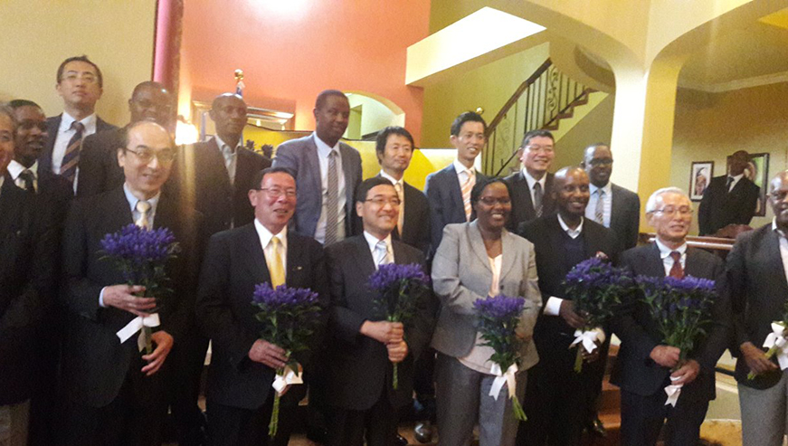 Officials pose for a group photo with harvested gentian flowers at the Japanese ambassador's residence. (All photos by Michel Nkurunziza)