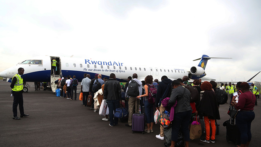 Passengers queue to board the plane this morning (Sam Ngendahimana)