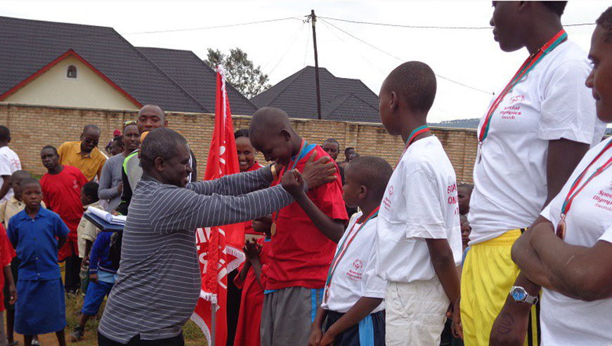 The Sports Director of the Ministry of Sports and Culture, Emmanuel Bugingo is seen here awarding best performers in a past Special Olympics event. (Jejje Muhinde)