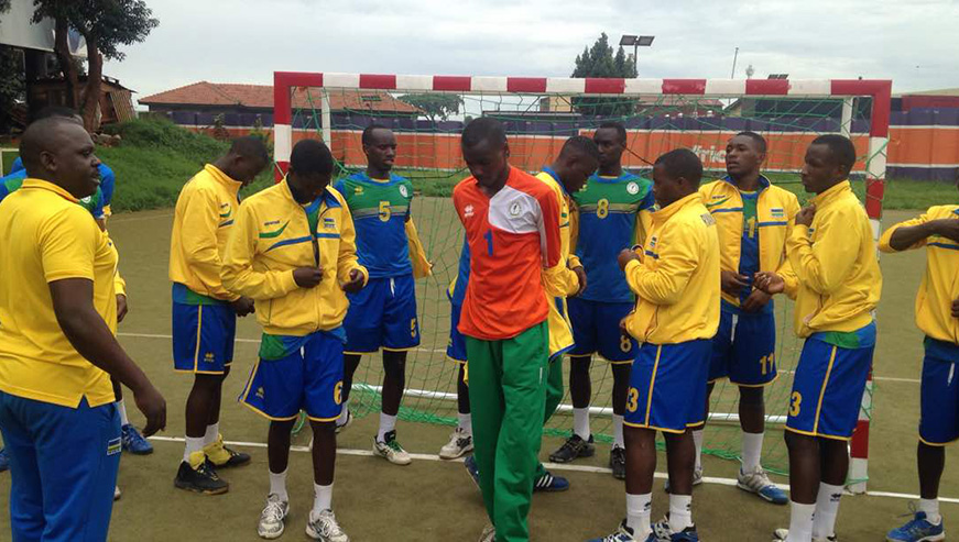 The Rwandan team listening to Coach Anaclet Bagirishya's instructions before routing Sudan on Wednesday afternoon. (Courtesy) 