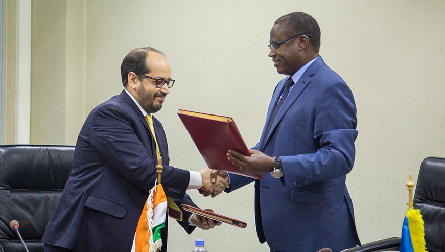 The Minister for Finance and Economic Planning, Dr UzzielNdagijimana, shakes hands and exchange documents with Tarun Sharma, General Manager and Regional Head of India Export Import Bank (EXIM) after the two signed the deal in Kigali yesterday. Nadege Imbabazi.