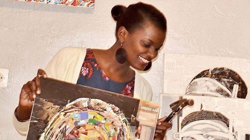 Crista Uwase shows off her finished paintings.