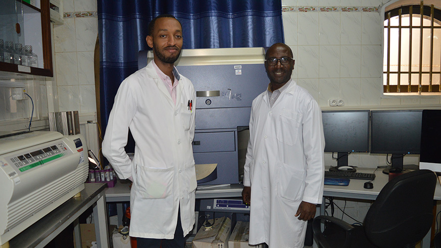 Dr Julien M. Nyombayire, (L) together with one of the staff members at PSF.