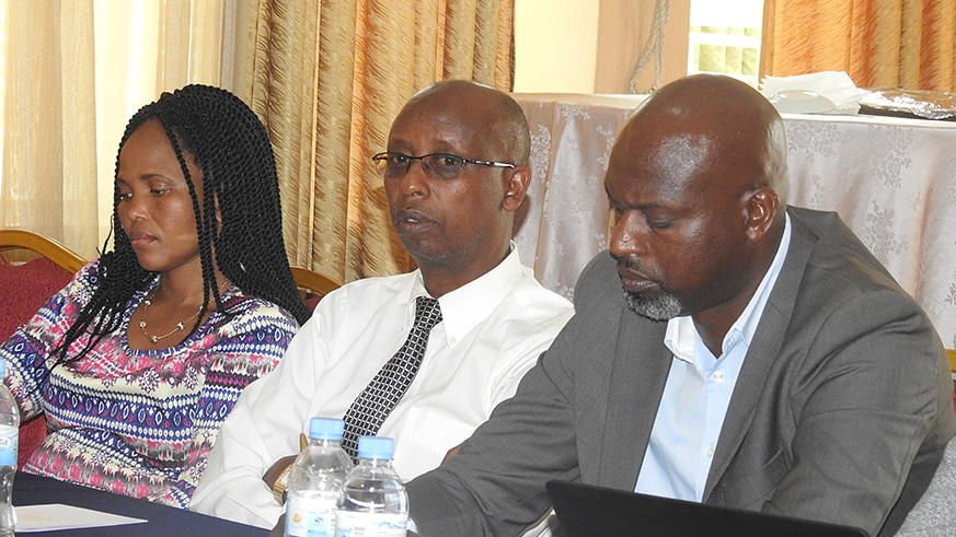 Methode Ruzindana, the Director of Research Department at Nyakinama Rwanda Peace Academy lloks on as other partcipants take their notes.Frederic Byumvuhore