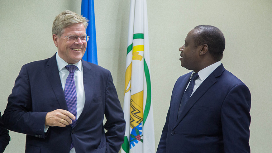 Ambassador  Woeste chats with Ndagijimana after the signing ceremony at the Ministry of Finance in Kigali yesterday. Nadege Imbabazi.