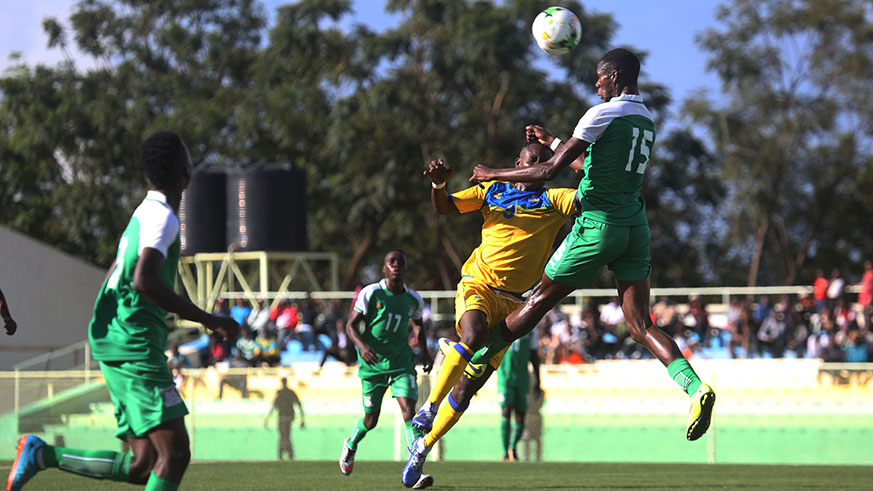 Zambian defender Thomas Zuru jumps for the ball against Amavubi striker Protais Sindambiwe during the first leg in Rwanda.  Sam Ngendahimana.
