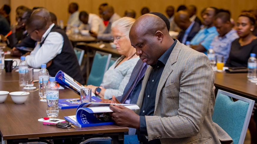 A participant goes through the bankâ€™s 2017 annual report during the annual meeting yesterday.