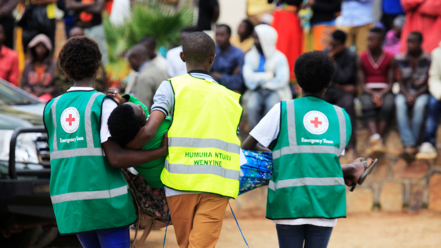 Volunteers carry a trauma victim during a commemoration event at Murambi genocide memorial last year. File.