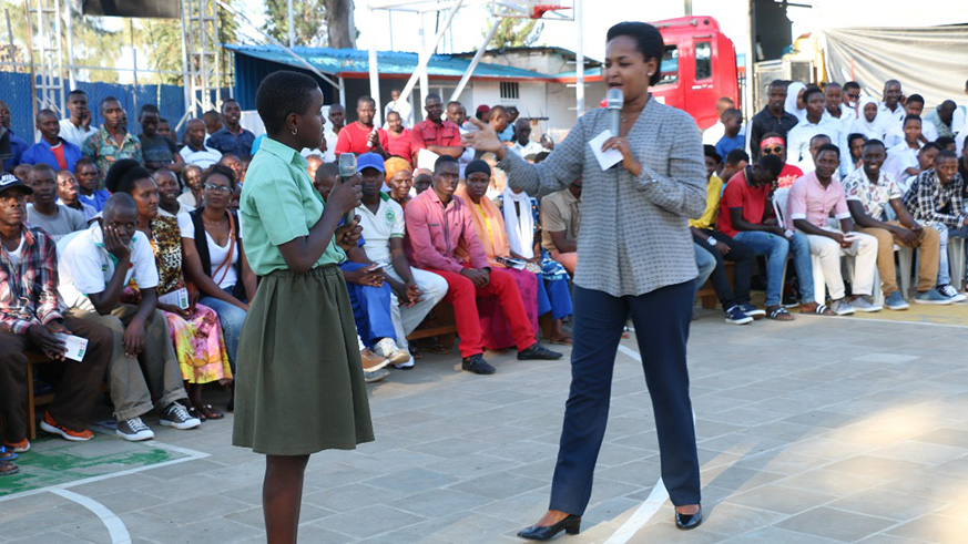 Minister Rosemary Mbabazi interacting with one of the students on the dangers of illicit drugs