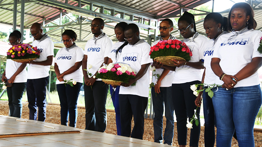 KPMG staff observe a minute of silence in honour of the victims of the 1994 Genocide against the Tutsi before laying wreaths at Nyanza Genocide Memorial.