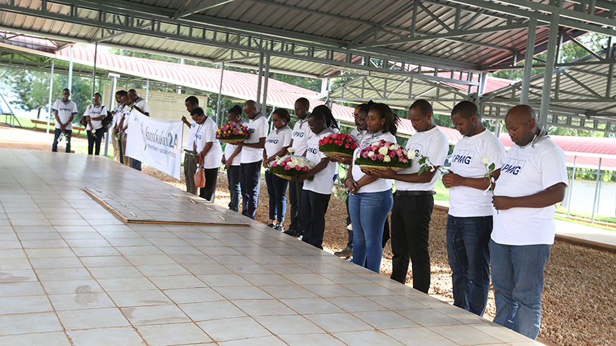 KPMG staff observe a minute of silence in honour of the victims of the 1994 Genocide against the Tutsi before laying wreaths at Nyanza Genocide Memorial.