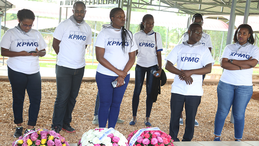 KPMG staff observe a minute of silence in honour of the victims of the 1994 Genocide against the Tutsi before laying wreaths at Nyanza Genocide Memorial.