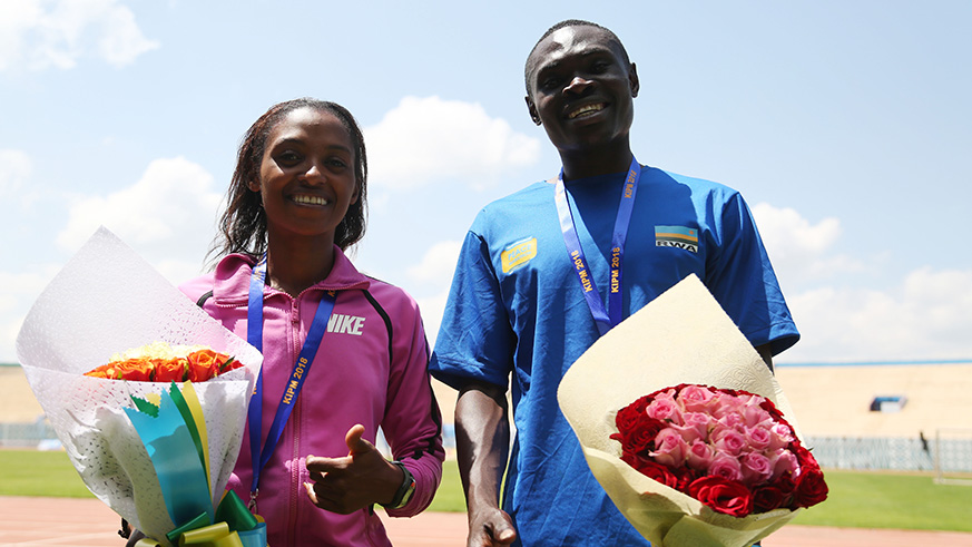 Rwandau2019s gold medalists Nyirarukundo and Hitimana pose with their medals after winning half marathon. Sam Ngendahimana.
