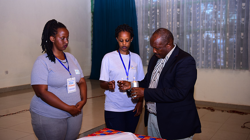 Ibuka president, Jean Pierre Dusingizemungu lighting candles to honor the victims. (Frederic Byumvuhore)