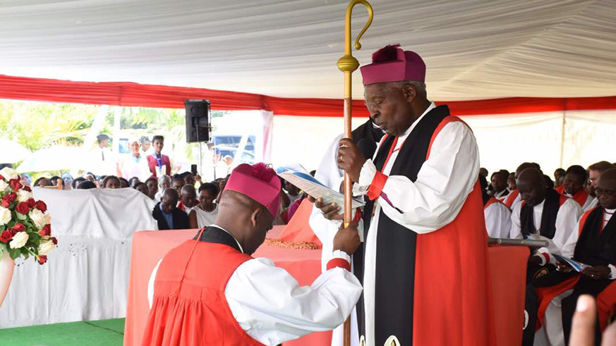 The Archbishop of Anglican Church in Rwanda, Onesphore Rwaje, praying for the new Bishop of Shyira Diocese, Samuel Mugisha Mugiraneza. Regis Umurengezi 