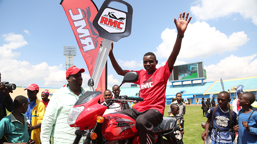 Long distance runner Thomas Dushimumukiza celebrates as he was awarded a brand new Motobike by RMC. He was selected to be the best youngest performer in Full Marathon