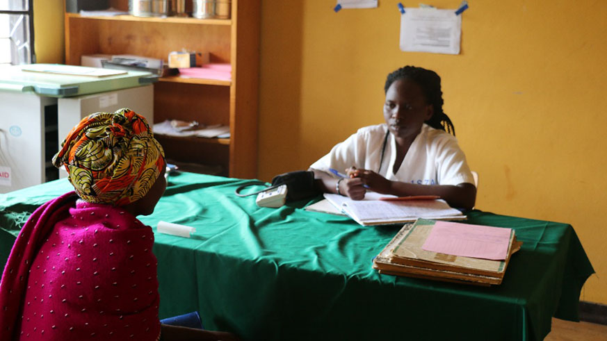 Claudette Nambage, a midwife at Sangaza health centre, attends to a patient. Courtesy.