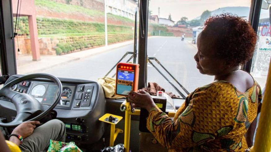 A city dweller uses her tap and go card on a Kigali bus. File