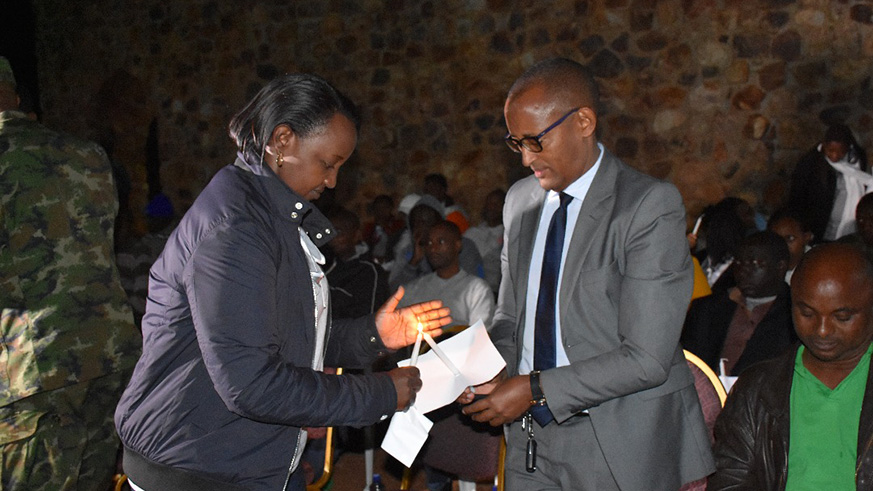Acting NIRDA Director General Claire Mukeshimana with Dr Deogene Bideri light a candle at the night vigil.