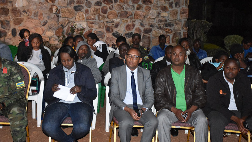 The congregation  sitting around a big fire during the night vigil as they paid tribute to former workers who perished during the 1994 genocide against the Tutsi.