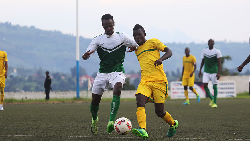 Djuma Nizeyimana battles for the ball with AS Kigali midfielder during the match