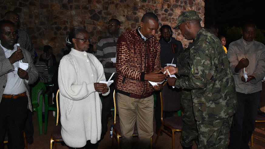 The congregation  sitting around a big fire during the night vigil as they paid tribute to former workers who perished during the 1994 genocide against the Tutsi.