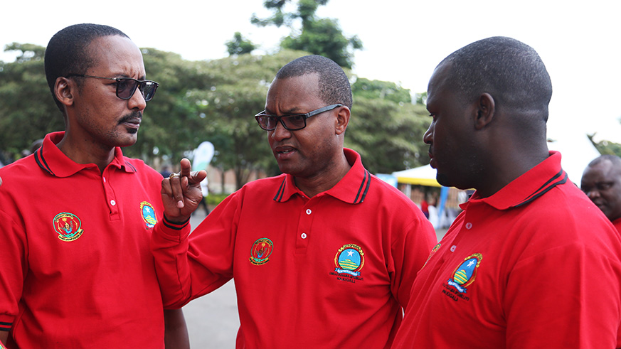 Rutabingwa (L) Busabizwa (C) and Janvier Gasana chat during the closure of Kigali City Councillorsu2019 Week at Petit Stadium in Kigali. / Sam Ngendahimana