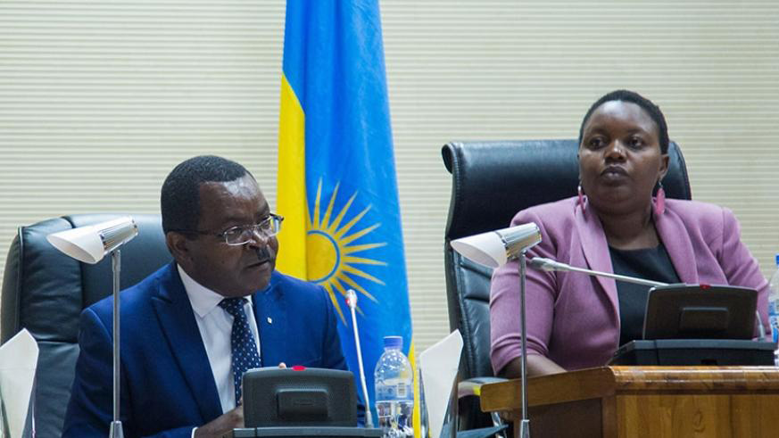 The Minister for Trade and Industry, Vincent Munyeshyaka (Left), addresses parliamentarians as the Deputy Speaker in charge of Legislation, Jeanne du2019Arc Uwimanimpaye, looks in a recent plenary session. / File.