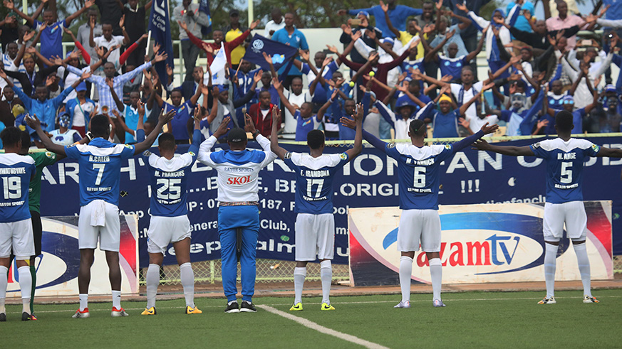Players and supporters celebrate the victory.