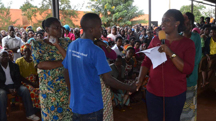 Jeanne Umutoni, the Vice Mayor in charge of social affairs (right), greets the eldest son of the six children, whose father allegedly murdered their mother, in Karenge Sector, Rwamagana District.