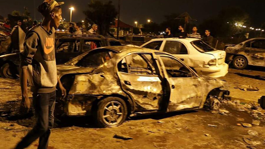 A man walks past a destoryed vehicle in the eastern Libyan city of Benghazi, Libya. (Net photo)