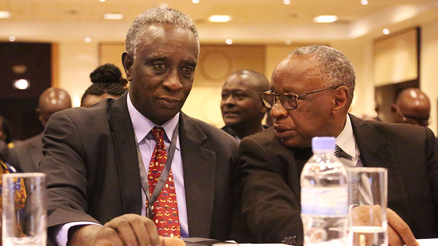 Bishop Rucyahana (right) chats with Mu00e9dard Rutijanwa, a former MP and one of the senior Pan-Africanists in the country, during the Pan-African Movement conference in Kigali yesterday.  Sam Ngendahimana.