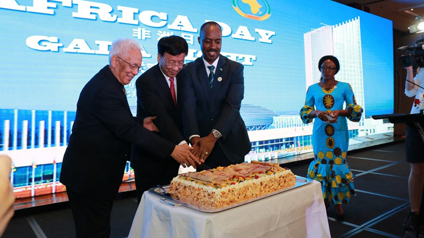 Amb. Kayonga (R) is joined by Victor Sikonina, the Ambassador of Madagascar and Dean of the African Diplomatic Corps (left) and Cao Jamming, the Vice Chairperson of the Standing Committee of Chinaâ€™s National Peopleâ€™s Congress to cut a cake in celebration of Africa Day. / Courtesy